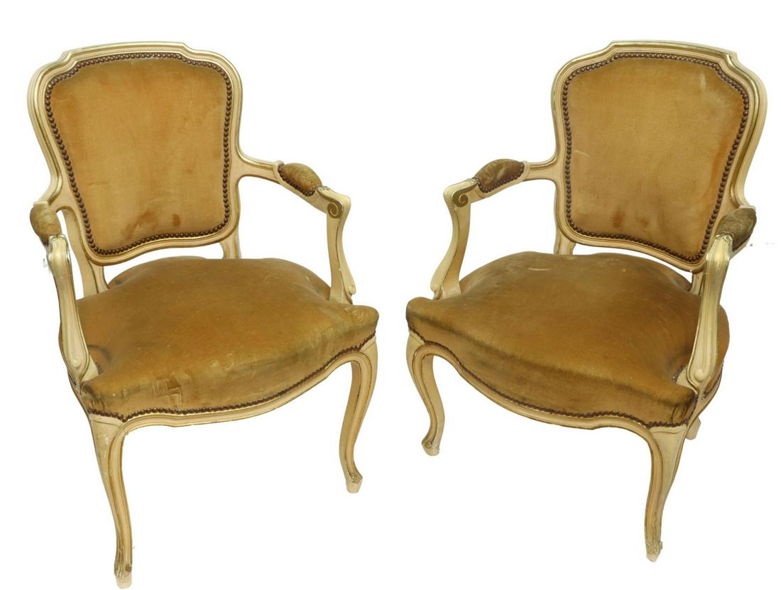 (2) ITALIAN LOUIS XV STYLE PARCEL GILT FAUTEUILS: (pair) Italian Louis XV style parcel gilt and painted armchairs, 20th c., having carved frames, padded and upholstered back, seat, and arms, fixed with nail head trim, rising on cabriole legs, wear to