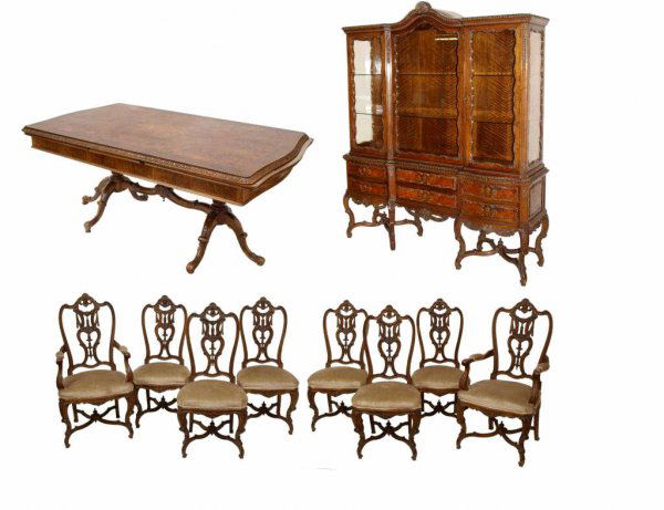 FINE SPANISH BURLED WALNUT DINING SUITE: (10pc) Spanish burlwood dining suite, c. 1930's, comprising a double pedestal draw leaf table, china cabinet, (2) arm and (6) side chairs, the set finely carved throughout with foliate and draped patt