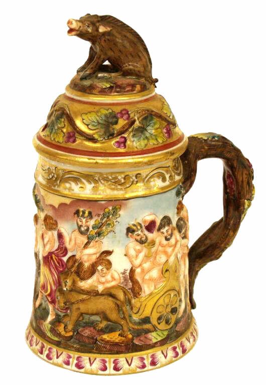CAPODIMONTE PORCELAIN FIGURAL RELIEF STEIN: Capodimonte porcelain stein, Italy, 19th c., polychrome and parcel gilt decoration in relief depicting a Bacchanalian scene with satyrs and The Three Graces, lid with boar form finial and grape vine o