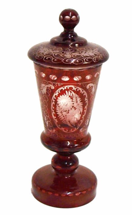 ANTIQUE BOHEMIAN RUBY TO CLEAR LIDDED POKAL: Bohemian goblet or pokal, late 19th/early 20th c., ruby cut to clear glass, elaborate etched floral motif, raised on a pedestal foot, surmounted by domed lid with round finial, 10"h, 3.5"w, 1.5lbs