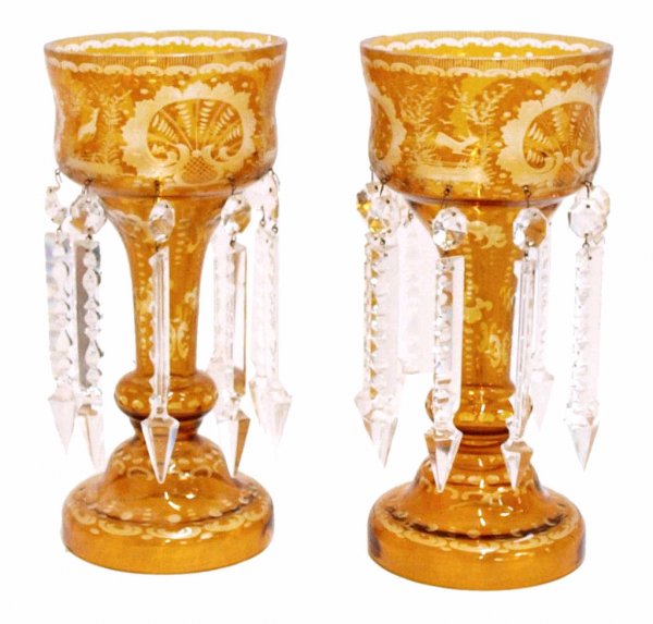 ANTIQUE BOHEMIAN INTAGLIO CUT AMBER LUSTRES: (pair) Large Bohemian intaglio cut glass lusters, 19th c., amber cut to clear, scenes of fowl, deer, along with foliate and geometric motifs, hung with elaborately faceted crystal prisms, flake to one