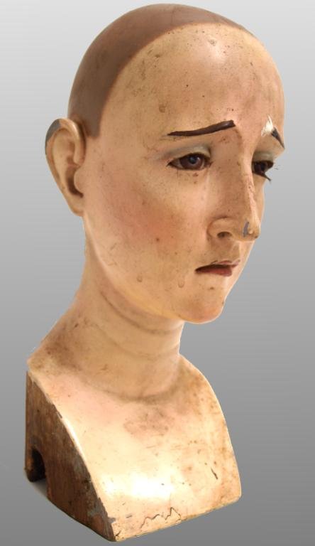 LARGE ANTIQUE RELIGIOUS CARVED WOODEN SAINT HEAD: Spanish Colonial carved wooden head, 19th c., an unidentified saint, polychrome decoration on the expressive face set with glass eyes and realistic lashes, 12"h, 5"w, 4.5"d, 2.25lbs