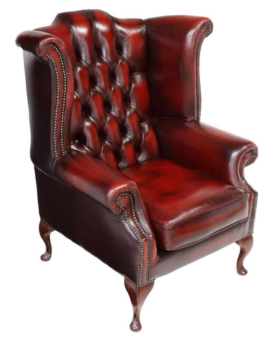 QUEEN ANNE STYLE OXBLOOD LEATHER WINGBACK ARMCHAIR: English Queen Anne style leather wingback armchair, late 20th c., oxblood upholstery with button-tufted back, bolster wings and arms, nail head trim, rising on cabriole legs, ending in pad feet, appro