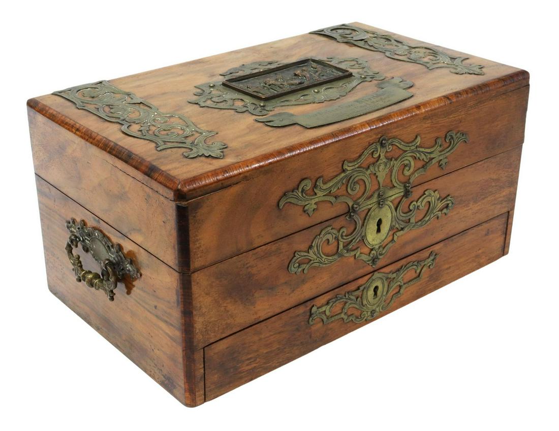 VICTORIAN WALNUT & BRASS TRAVELING GAMES BOX: Victorian walnut traveling compendium games box, late 19th c., having hinged lid, ornamented with brass foliate scroll mounts, centering cast relief figural salon scene and inscription plate, German i