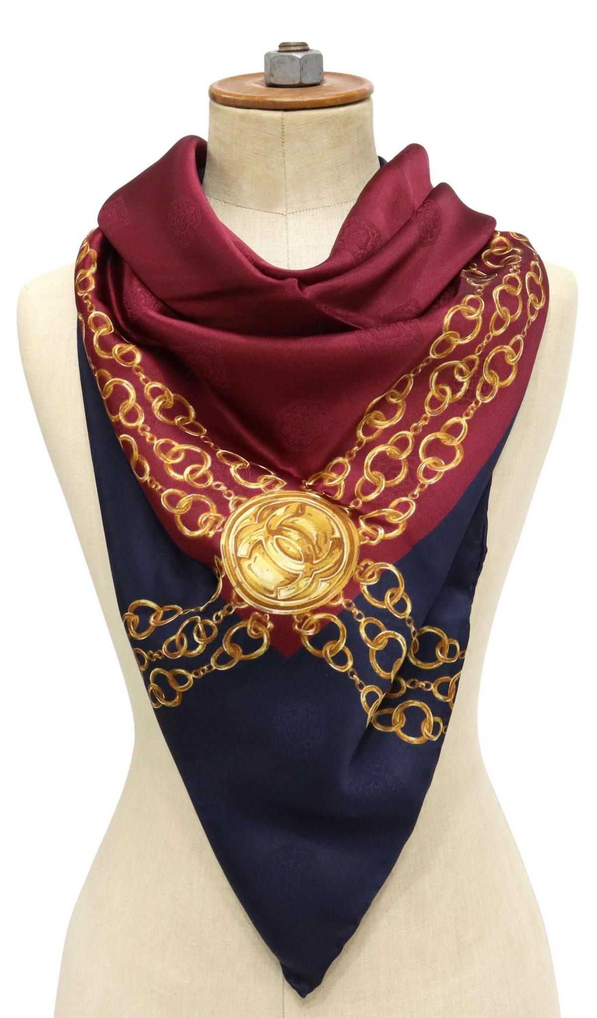 CHANEL ROYAL BLUE GOLD PENDANT & CHAIN SILK SCARF: Chanel silk scarf, in royal blue, gold and maroon, accented with chain link details with CC logo pendant, hand-rolled edges, marked Chanel in gold, scarf: approx 33"l, 33"w, 0.25lbs **Provenance: The 
