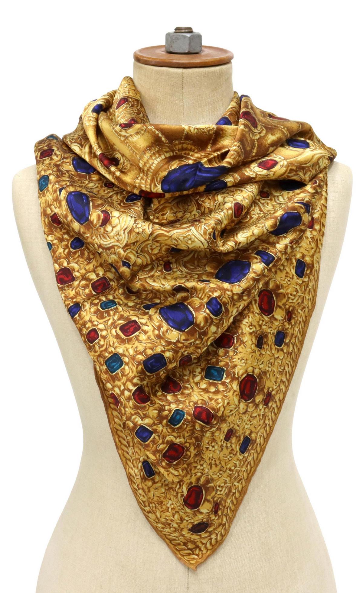 CHANEL GOLD & JEWELS SILK SCARF: Chanel silk scarf, gold ground with sapphires, rubies, and emeralds, hand-rolled edges, marked Chanel in gold, scarf: approx 38"l, 38"w, 0.25lbs **Provenance: The estate of a Houston Socialite who enj