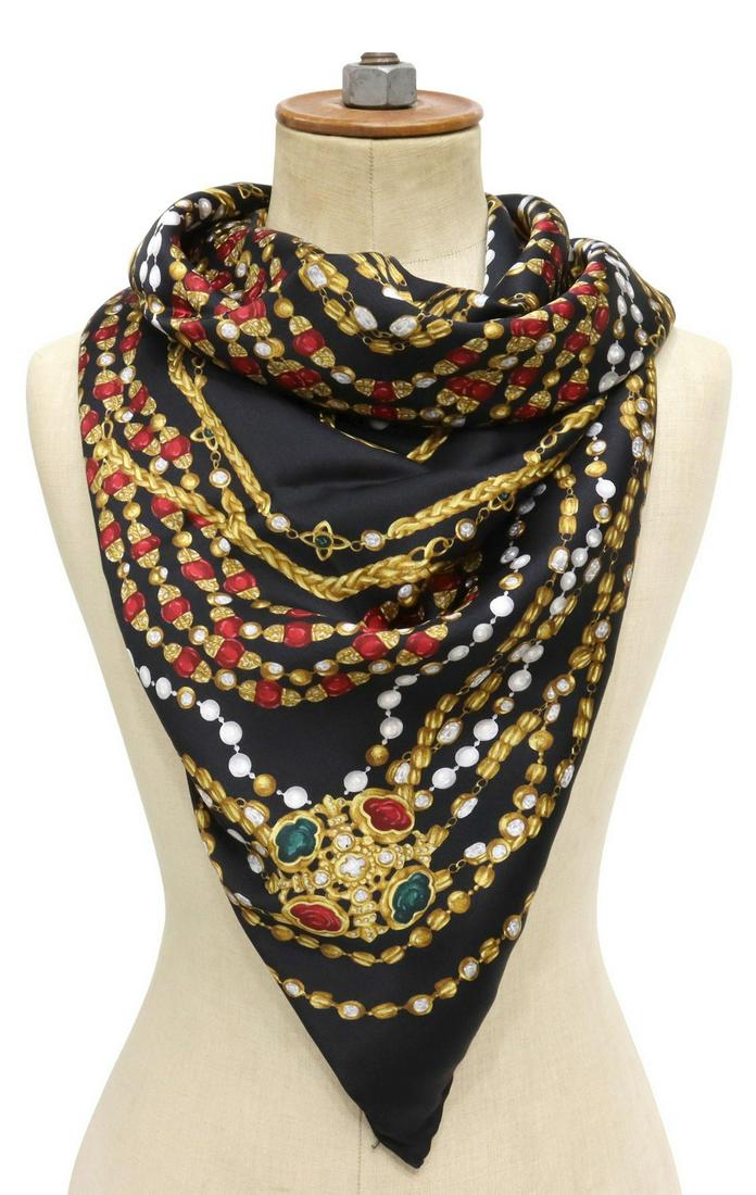 CHANEL BLACK JEWELS & GOLD CHAINS SILK SCARF: Chanel silk scarf, black ground with gold chains, ruby, emerald, and pearl jewels, hand-rolled edges, marked Chanel in gold, showing signs of wear, scarf: approx 34"l, 34"w, 0.25lbs **Provenance: The 