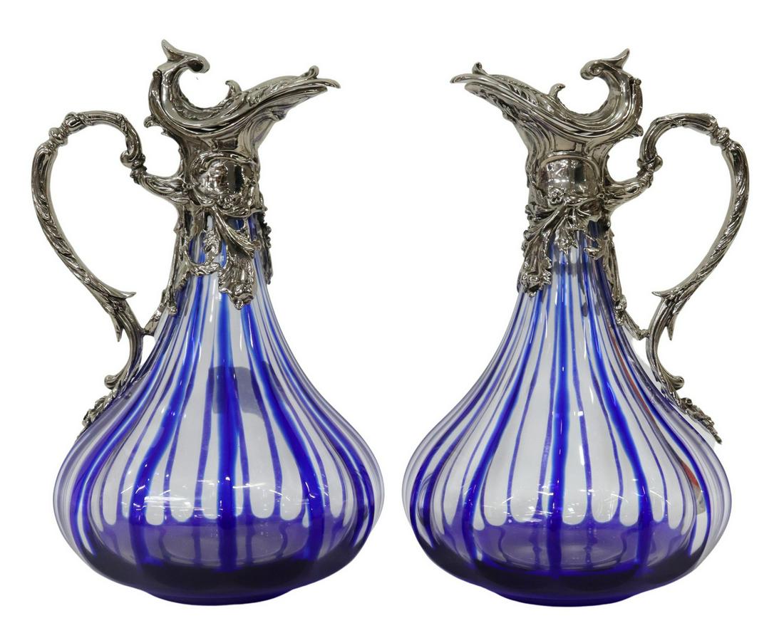 (2) MARTIN BENITO COBALT-CUT-TO-CLEAR GLASS EWERS: (pair) French cobalt-cut-to-clear glass wine ewers/ claret jugs, Martin Benito, late 20th c., silver plate hinged lid and scrolled handle, bulbous body with fluted design, engraved signature underfoot