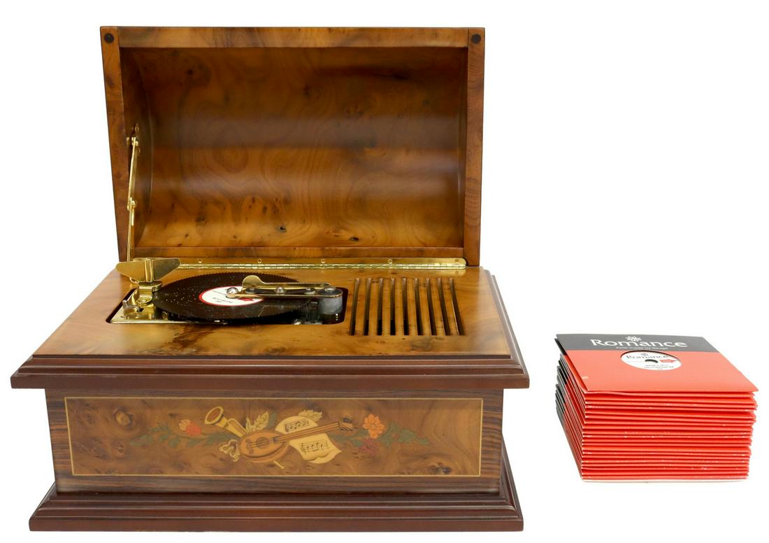 REUGE ROMANCE TREASURE CHEST MUSIC BOX & DISCS: (lot) Reuge Romance treasure chest music box, burlwood case with marquetry inlay of musical instruments and flowers, opening to 4.5" disc movement, 30 teeth, operating at this time, accompanied by (22