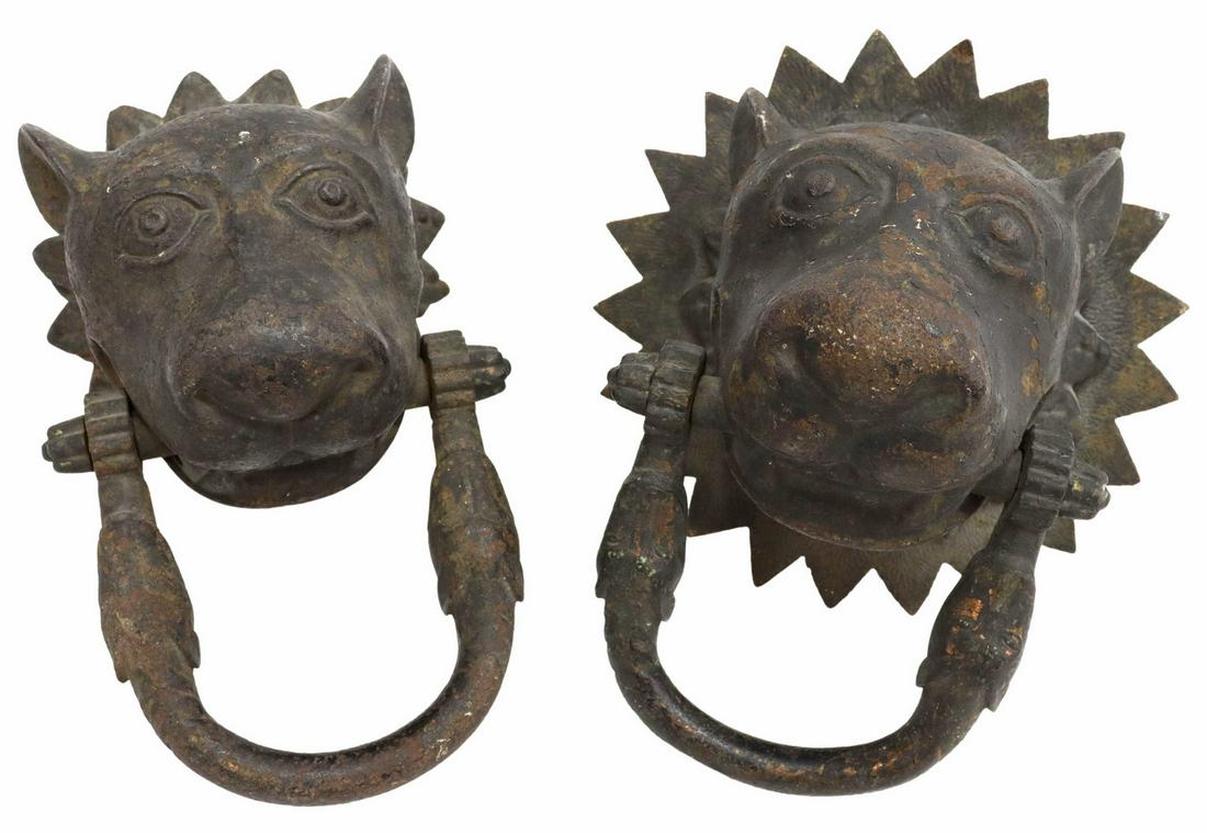 (2) ARCHITECTURAL CAST IRON FIGURAL DOOR KNOCKERS: (lot of 2) Early European architectural cast iron door knockers, lion's head with bared teeth, holding u-shaped bar with animal head terminals, (one) retaining backplate, approx 9"h, 7"w, 8.5"d; 24lbs