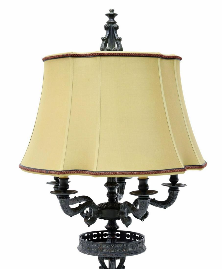 LARGE PATINATED METAL TWO-LIGHT LAMP, 53.5"H: Large patinated metal lamp, late 20th c., lyre harp finial, silk shade concealing two lights, five scrolled arms ending in faux candles, galleried platform, scrolled standard, on a foliated foot, over