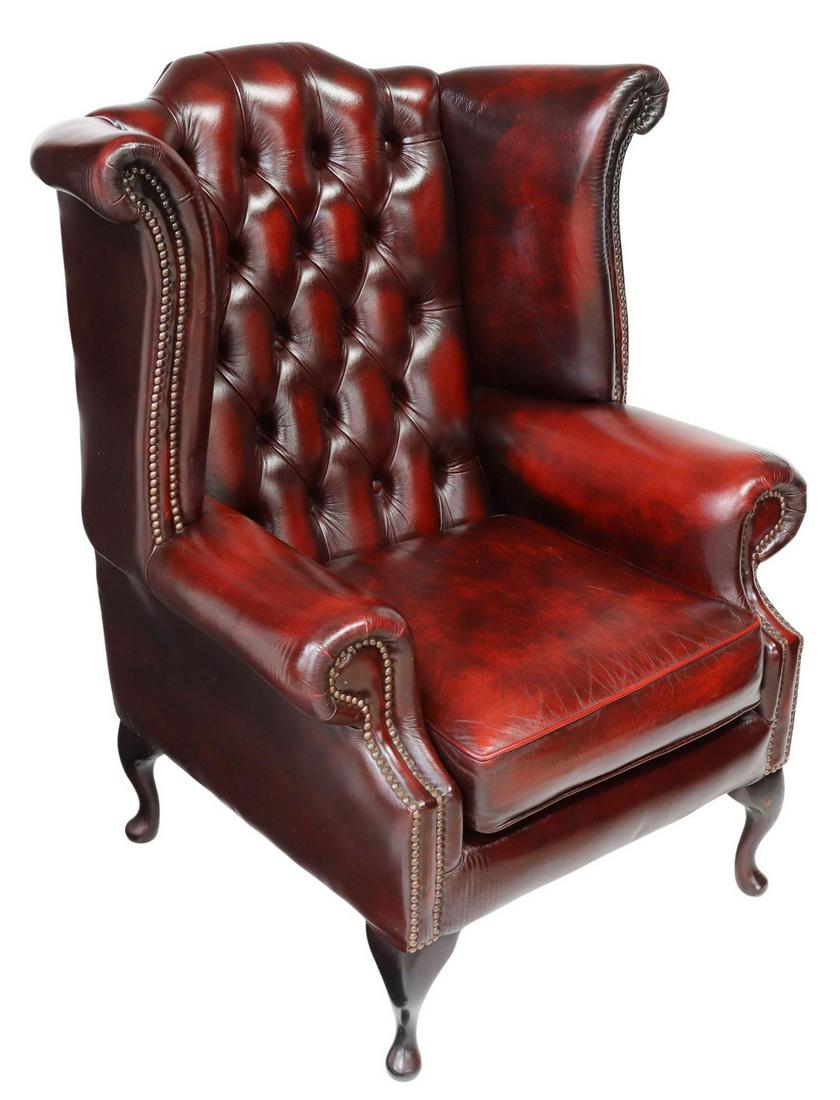 QUEEN ANNE STYLE OXBLOOD LEATHER WINGBACK ARMCHAIR: English Queen Anne style wingback armchair, late 20th c., oxblood leather upholstery, with button-tufted back, bolster wings and arms, nail head trim, loose seat cushion, rising on cabriole legs, endi