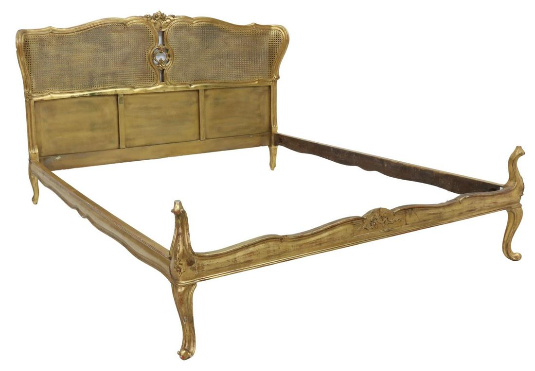 LOUIS XV STYLE GILTWOOD & CANE BED: Louis XV style giltwood bed, early 20th c., caned headboard with floral crest and curved ends, footboard with shaped uprights, rising on cabriole legs, exterior: approx 43.75"h, 81"l, 68"w, interior: