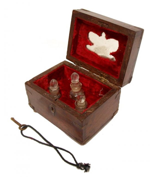 BRITISH COLONIAL BRASS BOUND ROSEWOOD PERFUME BOX: British Colonial brassbound rosewood perfumery box, late 19th c., the diminutive locking box having decorative brass and copper inlays, interior holding (3) enameled, parcel gilt glass scent bottles o