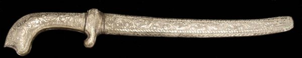 SOUTHEAST ASIA EMBOSSED METAL KRIS DAGGER & SHEATH: Southeast Asian metal keris dagger, sheathed, the sheath and grip having elaborate embossed foliate ornamentation, the blade corroded with age as pictured, 17"l, 2.75"w, 0.5lbs