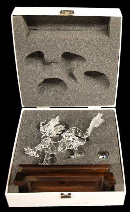 SWAROVSKI CRYSTAL DRAGON FIGURE WITH STAND: Swarovski crystal figure formed a dragon having faceted light topaz eyes, including iridescent crystal ball, teak wood stand, in original box, no loss noted, on stand: 5"h, 6"w, 1lb