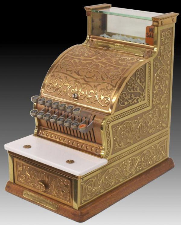 NATIONAL CASH REGISTER MODEL 311 ORNATE BRASS CASE: National Cash Register candy store register,Model 311, serial number (S189147E),ornate brass case, marble change shelf, all on oak base, interior dials for customer counts, number of sales & dollar am