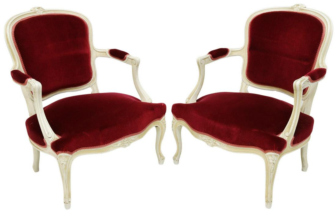 (2) FRENCH LOUIS XV STYLE UPHOLSTERED FAUTEUILS: (pair) French Louis XV style armchairs, 20th c., having carved and painted frames, accented with floral crest and apron, padded back, arms and wide serpentine seat, in red velvet upholstery, fixed wit