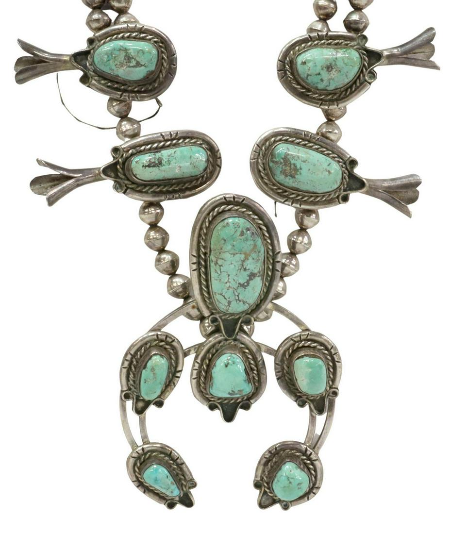 NATIVE AMERICAN TURQUOISE SQUASH BLOSSOM NECKLACE: Native American silver (content unknown) and turquoise squash blossom necklace, AS IS, featuring ten turquoise-set blossoms, central naja with six stones, double bench bead strands to either side deta