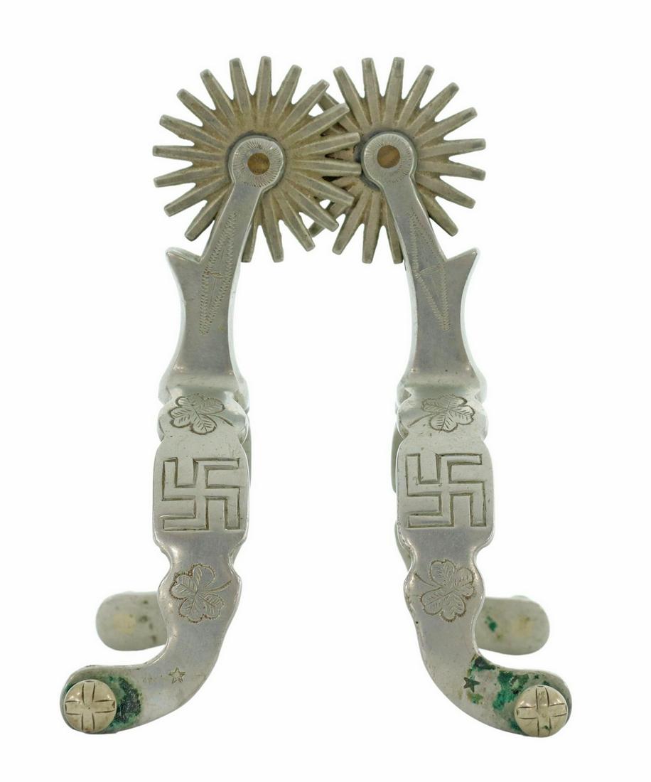 (PR) SCARCE AUGUST BUERMANN SWASTIKA COWBOY SPURS: (pair) Scarce August Buermann spurs, each with markings including AB within star, rolling log (swastika), two four-leaf clovers, Star Silver Steel, and cross mark on outside button, 1.75" rowels with