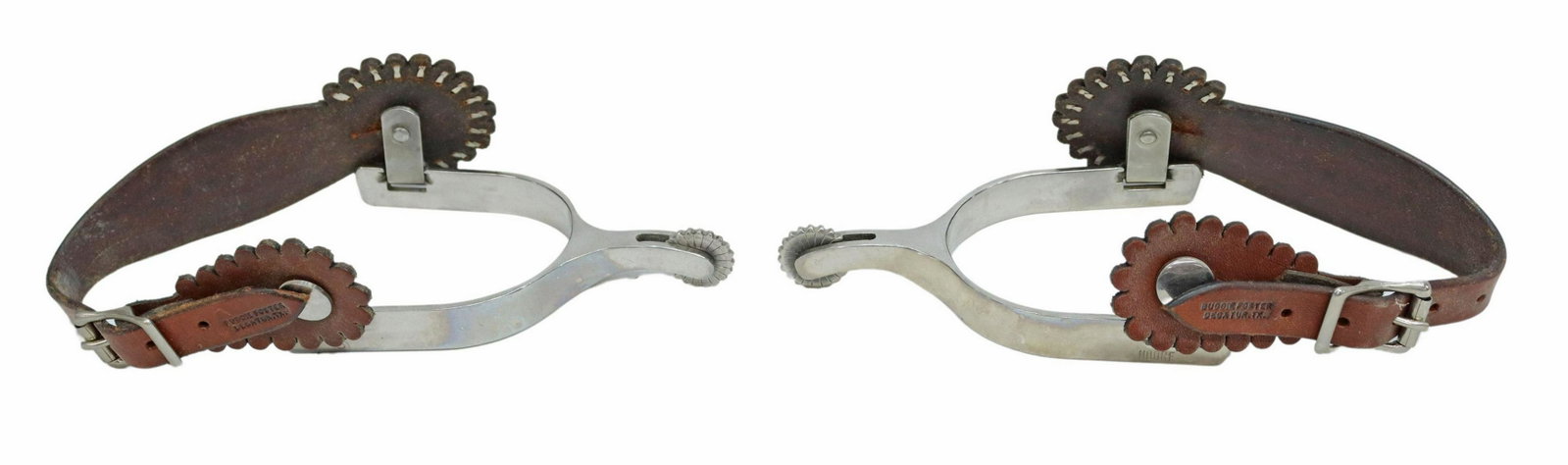 (PAIR) MOORE COWBOY SPURS TOOLED LEATHERS: (pair) Cowboy spurs, maker marked "Moore," stainless steel, further marked "S," 7/8" rowels, tooled leathers by Buddie Foster, Decatur, Texas, yoke: approx 3"w, 3.25"d Start Price: $80.00