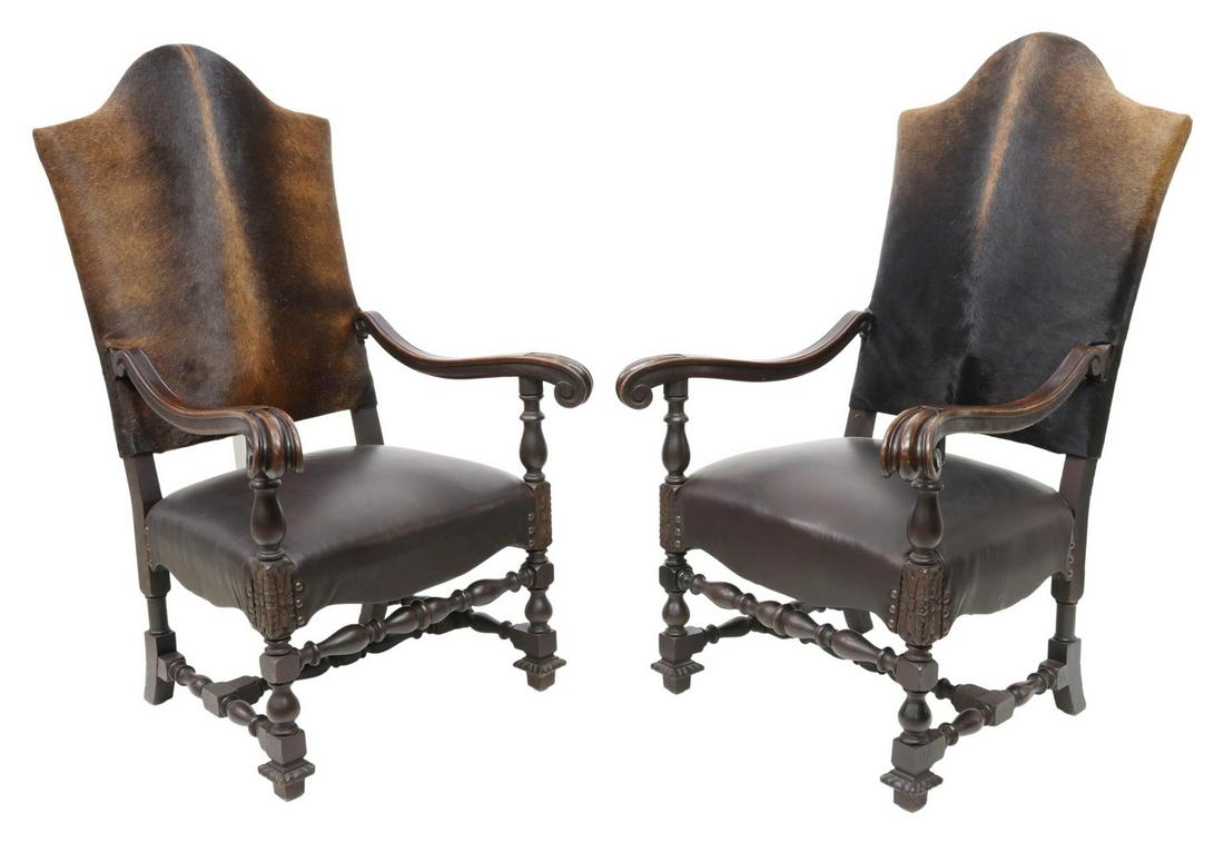 (2) BAROQUE STYLE COWHIDE & LEATHER ARMCHAIRS: (pair) Baroque style highback armchairs, 21st c., cowhide upholstered back over leather seat, scrolled handholds, rising on turned stretcher-joined legs, ending in block feet, approx 50.5"h, 29.5"w, 2