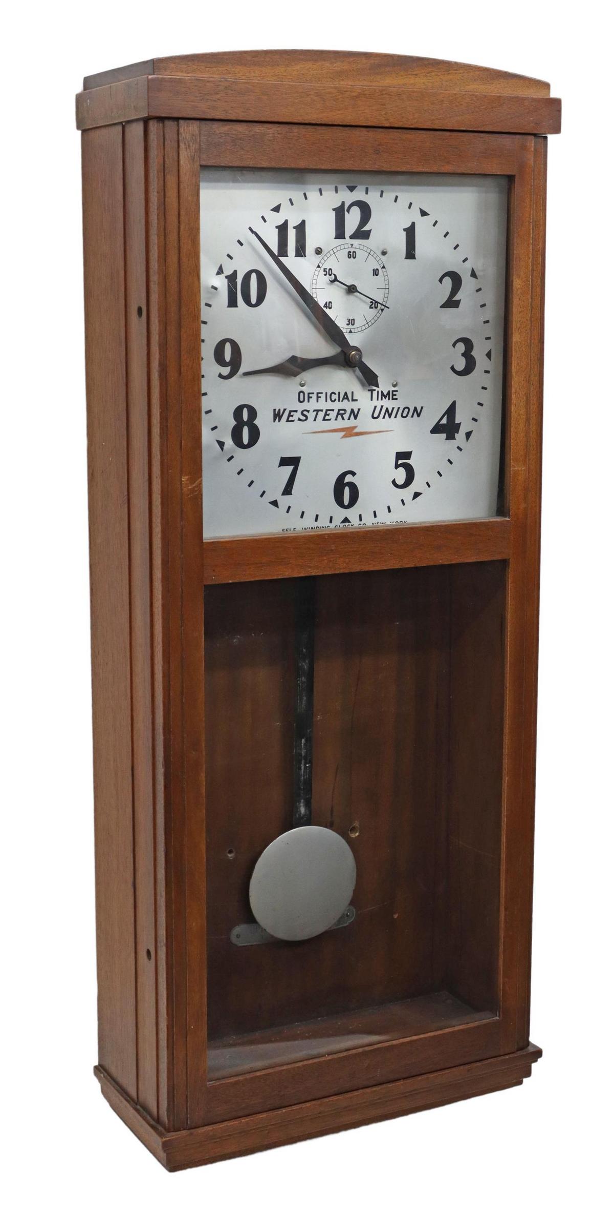WESTERN UNION OFFICIAL TIME SELF-WINDING CLOCK: Western Union wall clock, Self Winding Clock Company, New York, mahogany finish case, glazed door, silver-tone metal dial with Arabic numerals, seconds subdial, (one) dry battery detached, approx 38"h