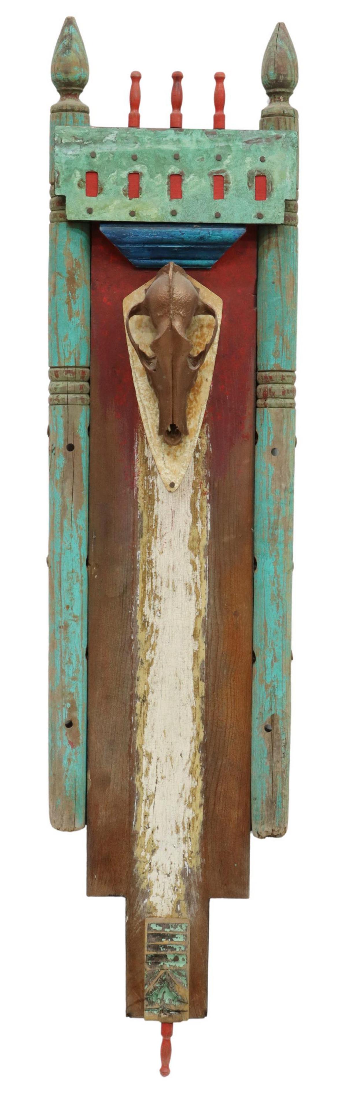 SOUTHWESTERN STYLE DECORATIVE SKULL WALL PLAQUE: Southwestern style decorative wall plaque, polychrome painted finish, turned finials, with gilt painted animal skull, overall wear and loss, approx 47"h, 10.5"w, 1.75"d Start Price: $80.00
