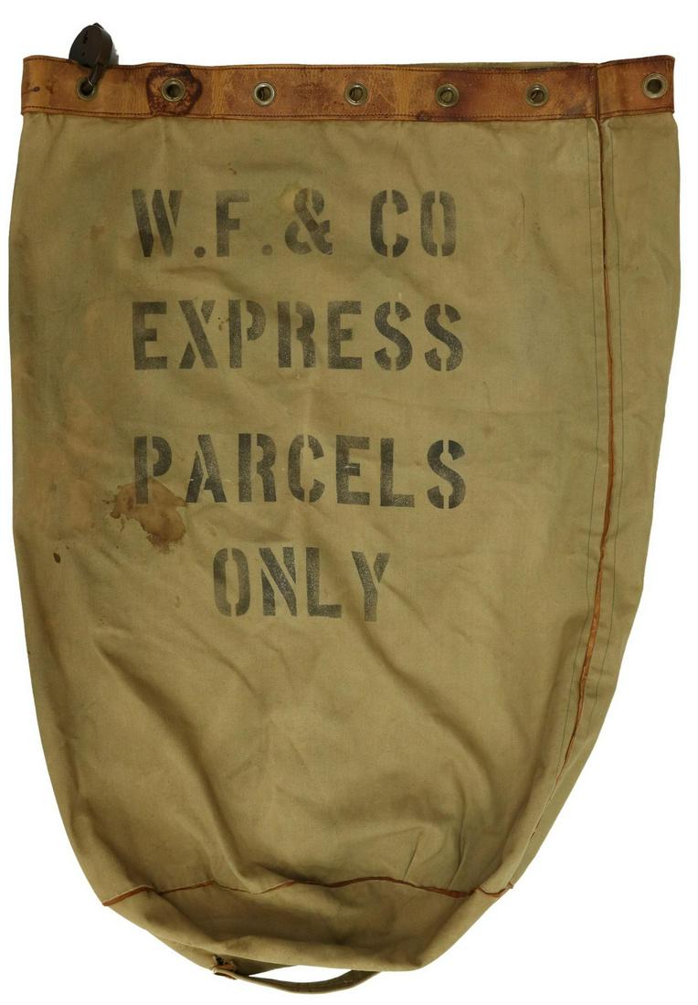 WELLS FARGO EXPRESS PARCEL BAG, BOHANNAN LOCK: Wells Fargo tapered parcel bag marked "W.F. & Co. Express Parcels Only," the top with a brass grommeted leather belt marked Spiro's San Francisco, an attached iron heart-form lock marked Wilson Bohann
