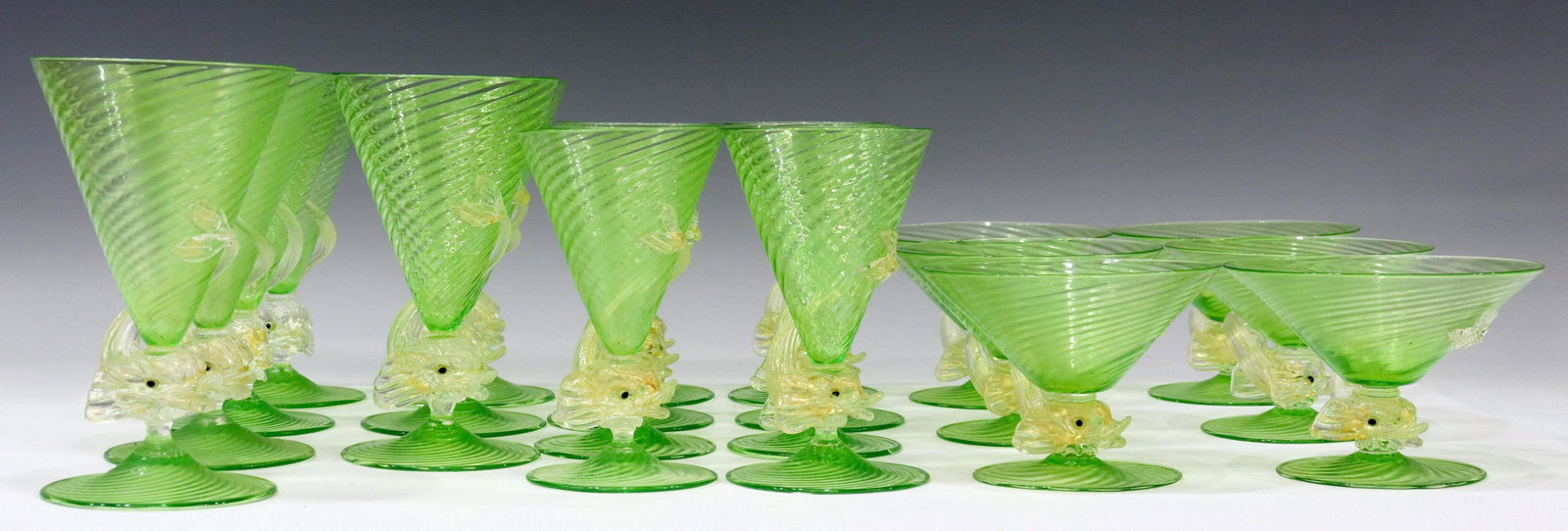 (21) VENETIAN MURANO ART GLASS DOLPHIN STEMWARE: (lot of 21) Venetian art glass stemware, in the manner of Salviati, mid 20th c., green swirl bowl and stem, with applied gilt-flecked dolphin, including: (7) water goblets, approx 6.75"h, 4"diam, (8) 