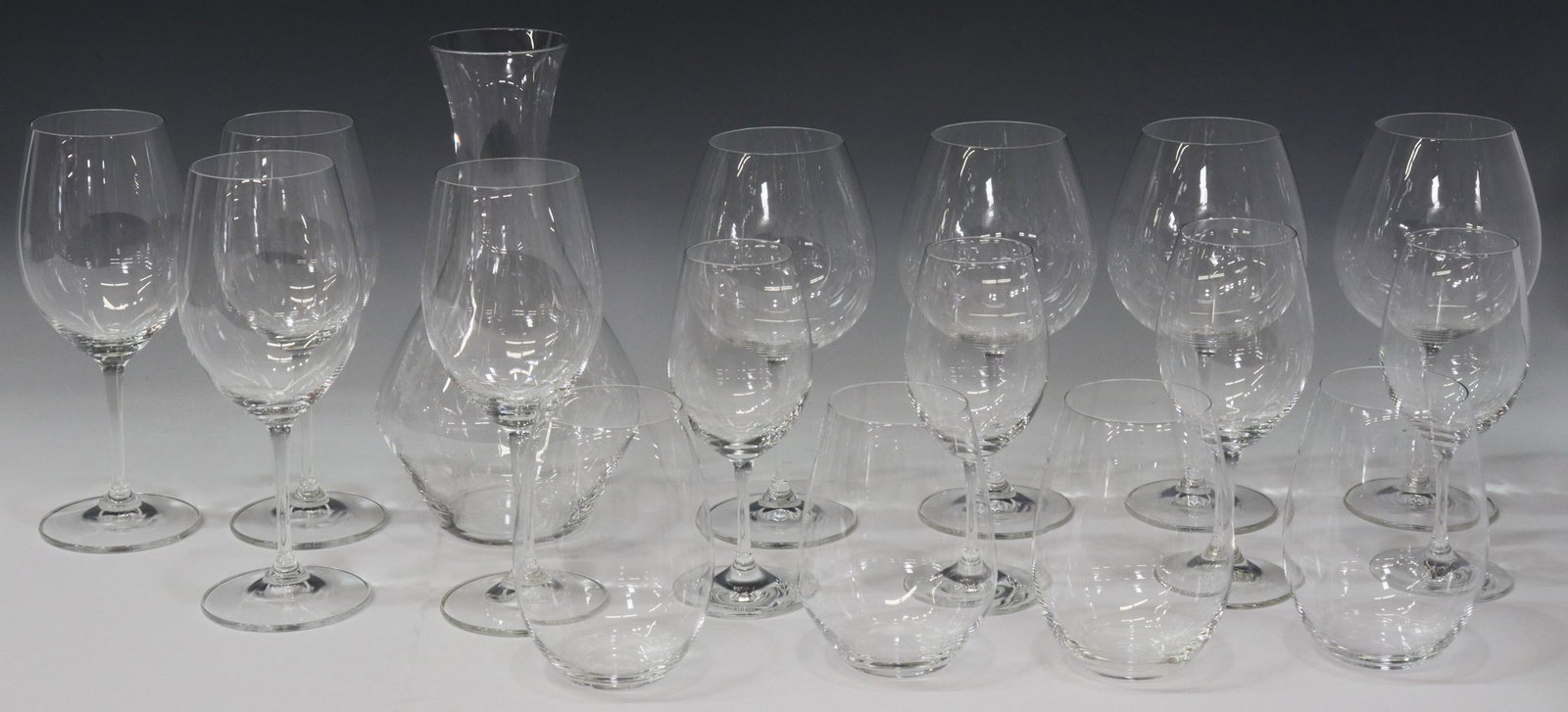 (17) RIEDEL COLORLESS GLASS WINE STEMS & DECANTER: (lot of 17) Riedel colorless glass stemware and decanter, all having acid-etched mark underfoot, comprising: (1) Cabernet/ Merlot decanter, approx 10.75"h, (4) general red wine glasses, approx 8 7/8"h