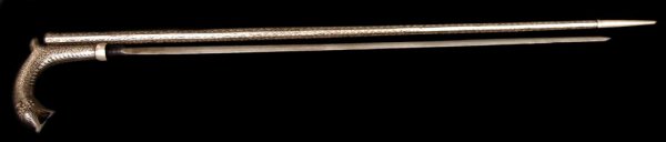 SILVERED WALKING STICK SWORD CANE, 1920'S: Bidriware style silver sword cane, India, 1920's, the handle formed as a horse head over the tapered walking stick, the handle unscrewing to reveal a 27" sword blade, overall 38" long, 6" wide handle,