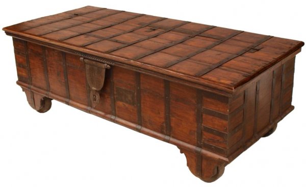ANTIQUE TEAKWOOD & IRON STORAGE CHEST ON WHEELS: Large teakwood storage chest, India, first half 19th c., the iron banded rectangular box with hand forged 6" wide lock hasp, spacious interior, moving on wood wheels, suitable for use as a day bed, 25