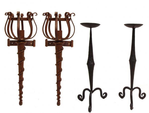 IRON TORCH FORM WALL SCONCES & (2) CANDLE STANDS: (lot of 4) Iron wall sconces and candle stands : (2) candle sconces formed as torches, iron with a red and gilt wash, 23"l, 7.5"w, 10"d; (2) hammered iron candle stands, tapered body and round candle