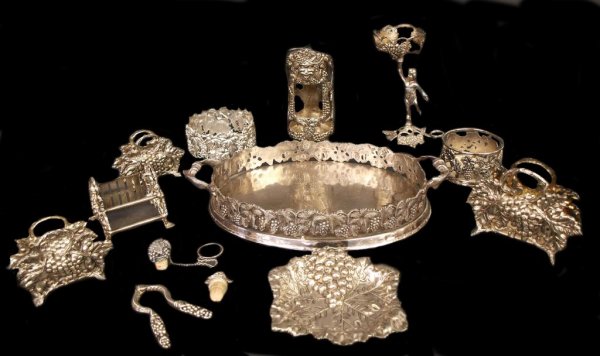 COLLECTION SILVER PLATE GODINGER GRAPE BARWARE: (lot of 13) Grape motif metal service articles and barware comprising: 1) large double handled tray, rim formed as a pierced grapevine, 18"l, 10"w; (1) handled wine bottle stand by Godinger Silver Art
