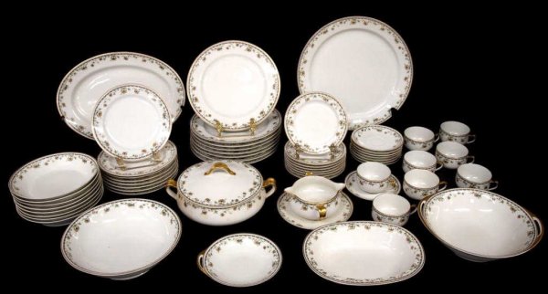 HAVILAND LIMOGES GILT PORCELAIN DINNER SERVICE: (lot of 56) Haviland Limoges porcelain dinner service for eight plus extras, decorated with running floral ornamentation and heavily gilt edges comprising: (8) dinner plates, 9.75"d; (8) salad plates,