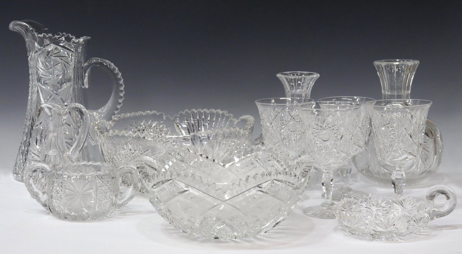 (12) AMERICAN BRILLIANT PERIOD CUT GLASS TABLEWARE: (lot of 12) American Brilliant Period and other cut glass tableware, in varied hobstar, fan, pinwheel, and diamond patterns, comprising: (4) wine stems; (2) carafes; (1) oil cruet; (1) open sugar bowl