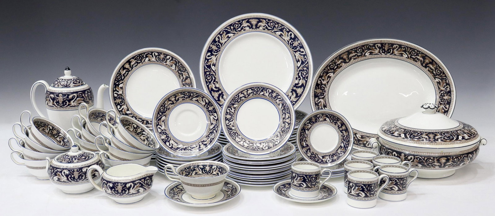 (75) WEDGWOOD FLORENTINE PORCELAIN DINNER SERVICE: (lot of 75) English Wedgwood porcelain dinner service, in the "Florentine" pattern, 20th c., comprising: (12) dinner plates, approx 10.75"diam, (11) salad plates, approx 8.25"diam, (13) bread and butt