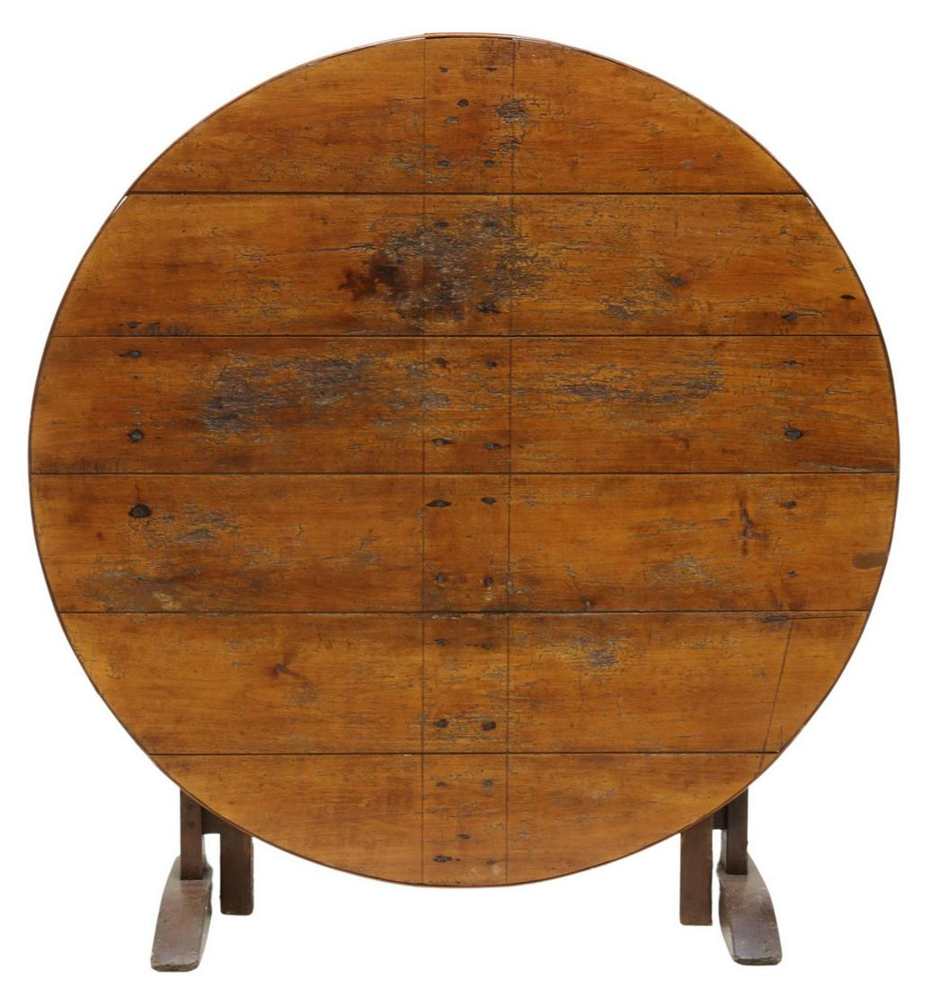 RUSTIC FRENCH FRUITWOOD & OAK WINE TASTING TABLE: French Provincial wine tasting table, 19th c., having round hinged fruitwood top, rising on an oak base, with gate leg, open: approx 27"h, 44.5"diam; folded: approx 47"h Start Price: $250.00