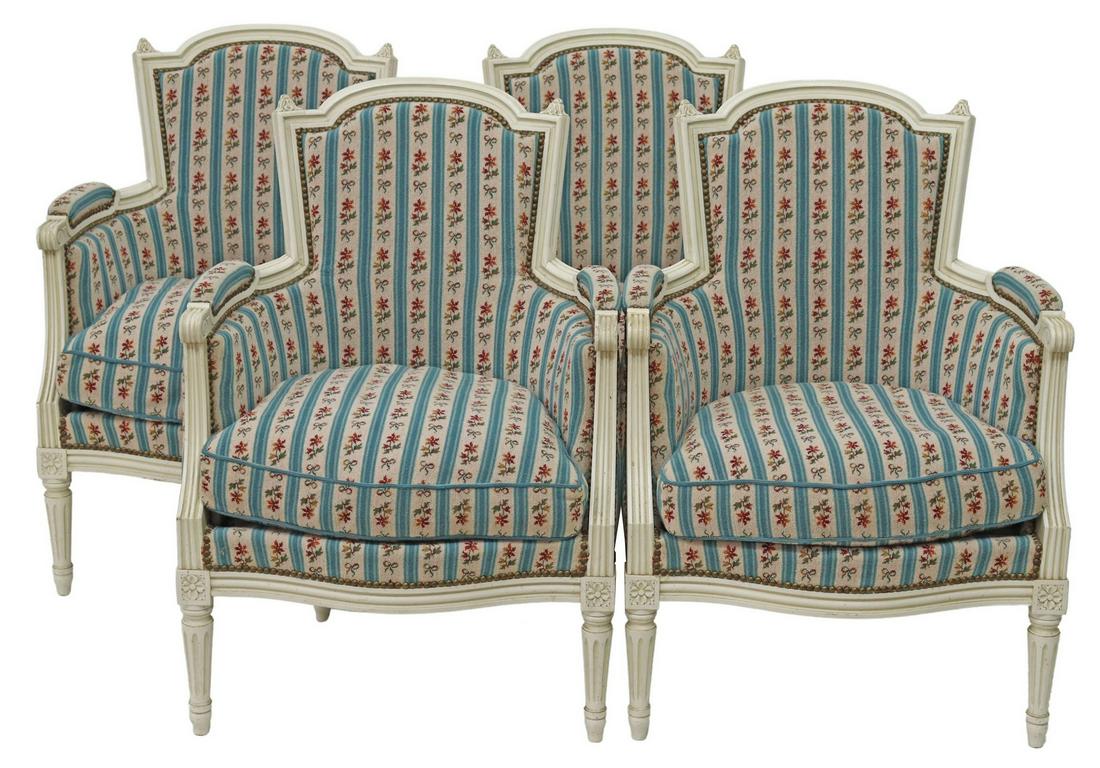 (4) FRENCH LOUIS XVI STYLE UPHOLSTERED BERGERES: (lot of 4) French Louis XVI style armchairs, 20th c., having painted and carved frames, with closed arms, padded seat and back, in stripped floral textile, removable cushion, rising on tapered fluted 
