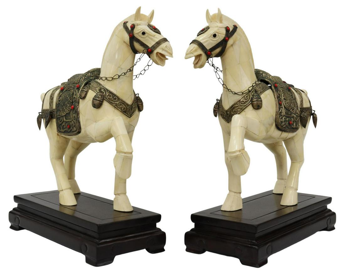 (2) LARGE CHINESE TANG STYLE BONE HORSE FIGURES: (pair) Large Chinese Tang style tiled bone horse figures, depicted walking, fitted with white metal bridle and saddle, decorated with red cabochons and hanging ornaments, presented on wooden stand, fi