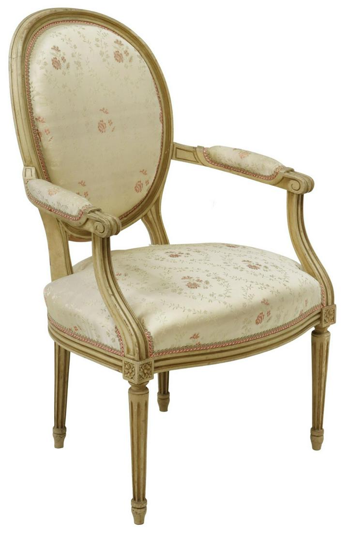 FRENCH LOUIS XVI STYLE MEDALLION BACK FAUTEUIL: French Louis XVI style armchair, early 20th c., having foliate carved frame, oval medallion back and seat in floral upholstery, scrolled handholds, rising on fluted tapered legs, ending in blunt arrow