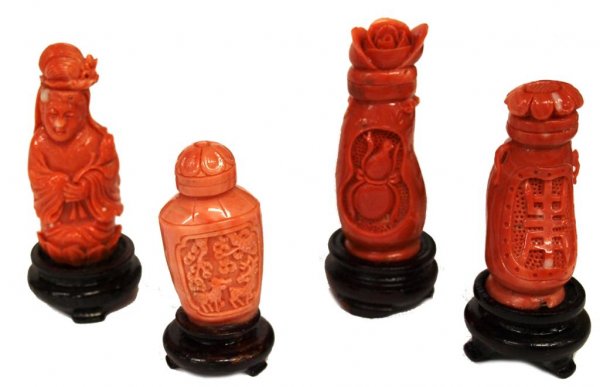 CHINESE CARVED RED CORAL SNUFF BOTTLE SCULPTURES: (lot of 4) Carved red coral sculptures in the form of snuff bottles, (1) a woman, (1) an urn with deer in relief, (2) of eggplant form having characters, beetles in reserve; all raised on lacquered wo