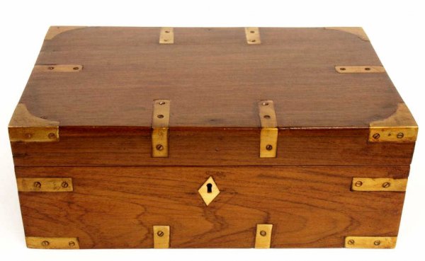 BRITISH COLONIAL BRASS BOUND TEAKWOOD CAMPAIGN BOX: British Colonial teakwood campaign box, 19th c., the rectangular box having brass bindings and inset campaign handles, interior lid fitted with document slot, restored, 6"h, 15.75"l, 10.5"w, 11.25lbs 