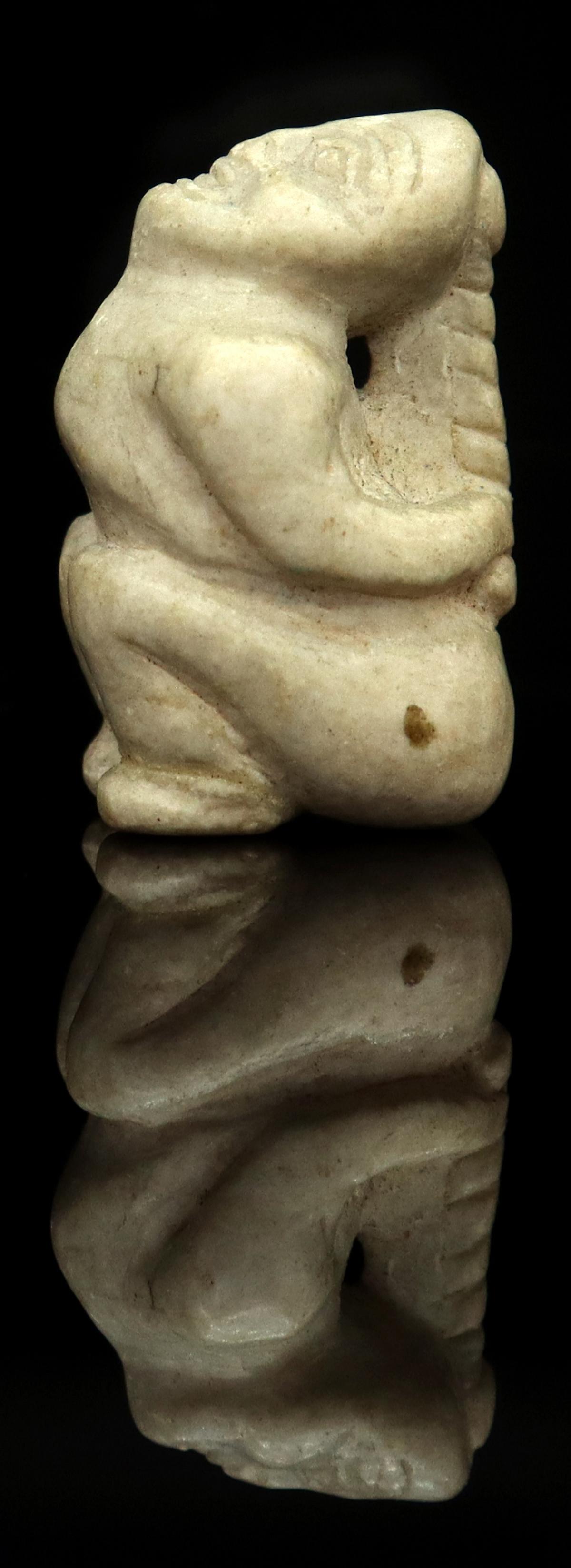 NORTHWEST COAST WITCH STONE CARVING, 1"H: Northwest Coast witch stone carving, the figure bound tightly by her hair braid causing her head to be pulled back, approx 1"h, 5/8"w *Provenance: Estate of James E. Rubins (1916-2006), a longtime tea