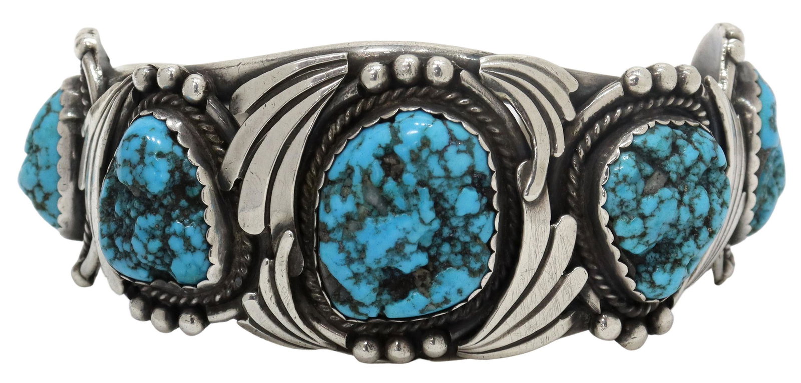 SOUTHWEST SILVER & TURQUOISE CUFF BRACELET: Southwest silver (content unknown) cuff bracelet, signed J.B.C., five bezel-set turquoise stones, in surround of twisted wirework, bead and stylized accents, on a two-prong cuff, approx 1.25"w, interi