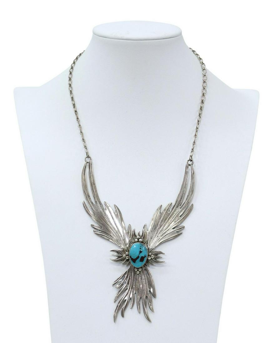 NATIVE AMERICAN STERLING & TURQUOISE NECKLACE: Native American sterling silver necklace, signed at back of pendant, articulated stylized feathers, central bezel-set turquoise, overall: approx 22"l, pendant: approx 8"l, 3.25"d, 67 grams (inclusive 