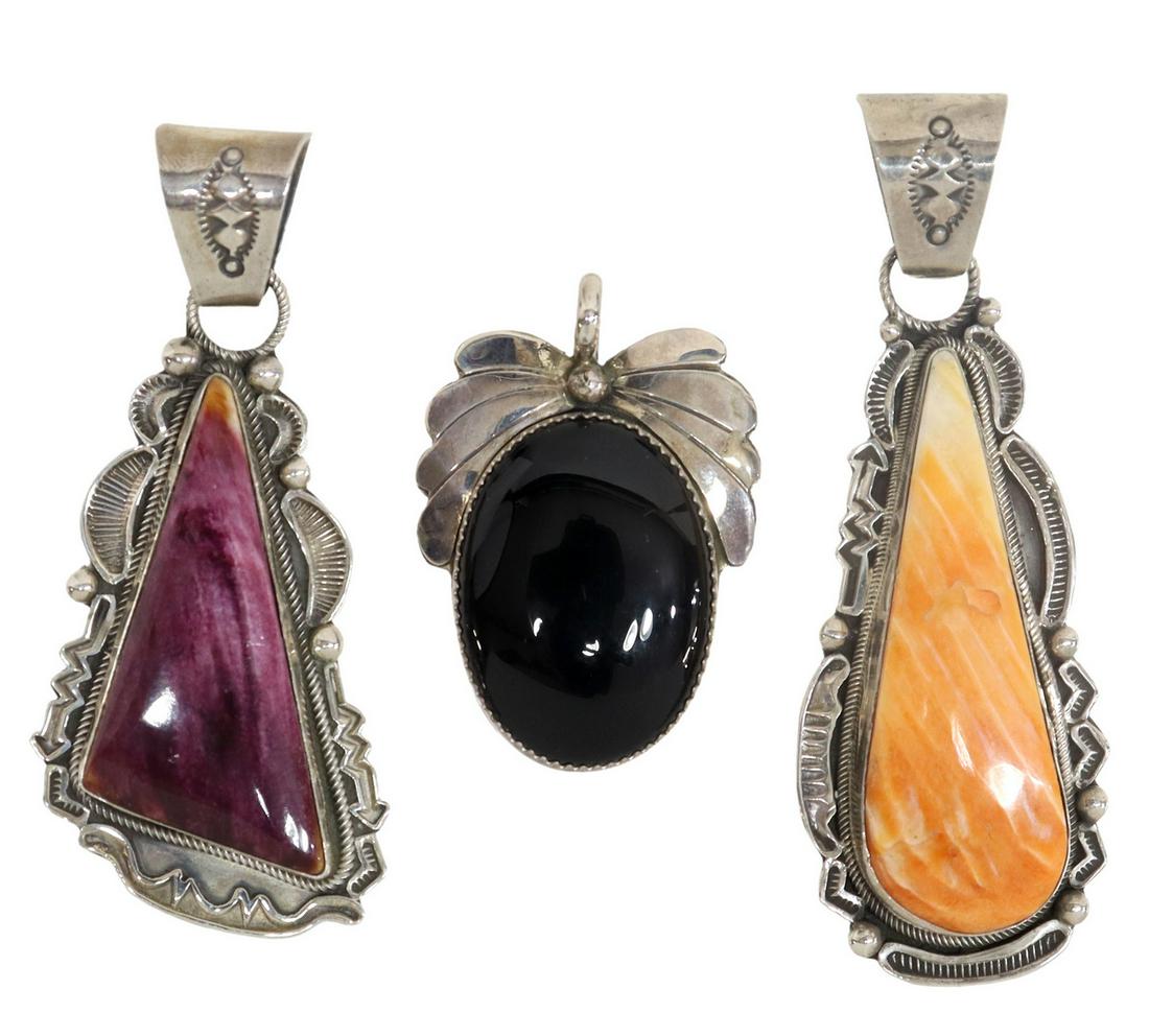 (3) NATIVE AMERICAN STERLING SILVER PENDANTS: (lot of 3) Native American sterling silver pendants, comprising: (2) signed R. Tom (Randall Joe Tom, Navajo, 20thc.), both in owrked bezel with stamped bail, (one) with bezel set purple spiny oyster, 