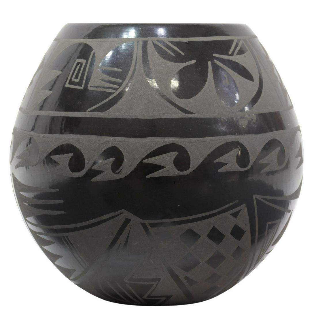 CARMELITA DUNLAP SAN ILDEFONSO PUEBLO POTTERY OLLA: Native American blackware olla, signed at the underside Carmelita Dunlap (San Ildefonso Pueblo, New Mexico, 1925-1999), accompanied by a certificate of authenticity from the Gilbert Ortega Native Amer