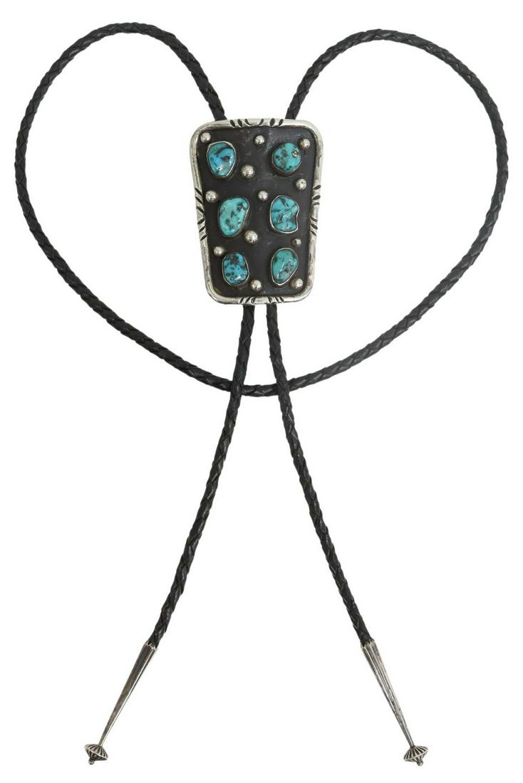 NATIVE AMERICAN SILVER & TURQUOISE BOLO TIE: Native American silver (content unknown) bolo tie, signed "for luck $, Uncle Claud, love, your niece Vicki, SF, VLD, 1993," bolo ornament with six bezel-set turquoise stones, silver bolo tips, on a br